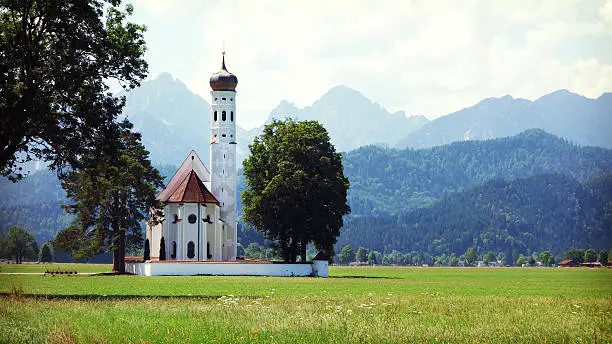 Idyllic St. Coloman Church near Neuschwanstein Castle, Hohenschwangau in Germany. The Neuschwanstein Castle was commissioned by Ludwig II of Bavaria as a retreat and is located in Hohenschwangau in the Bavarian Alps. 