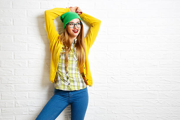 istock Smiling Hipster Girl at White Brick Wall Background 502920936