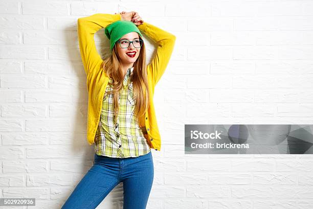 Smiling Hipster Girl At White Brick Wall Background Stock Photo - Download Image Now