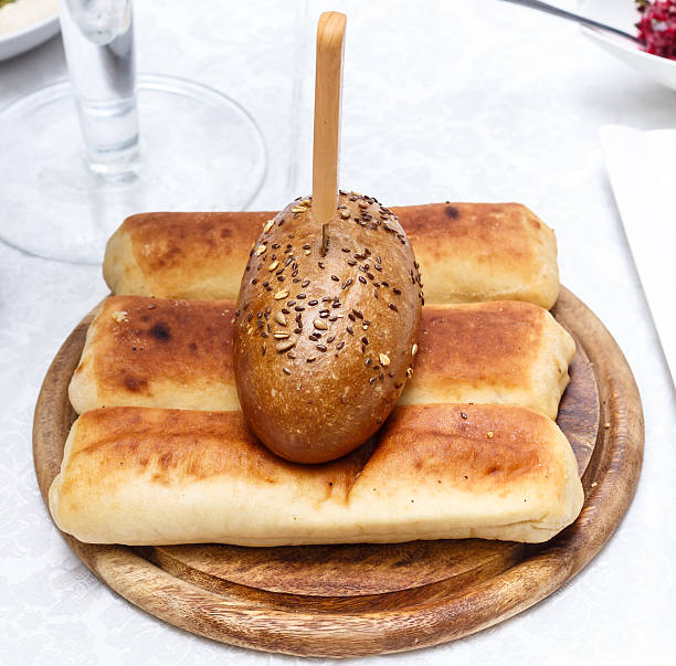 istock Bread with sesame seeds on a wooden platter 502921340
