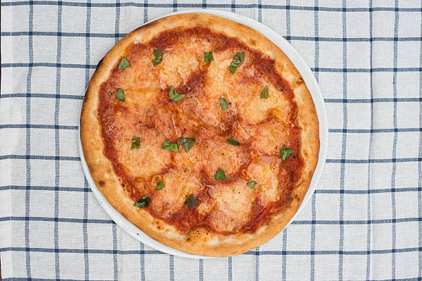 istock pizza margherita on white and blue graphed towel 502923034
