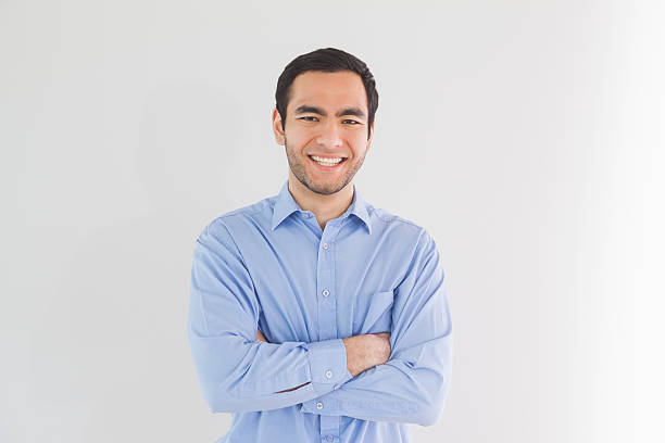 istock Smiling man standing with arms crossed and looking 502932587