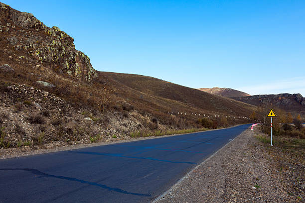 istock Mottled asphalt road mountains in morning 502933350