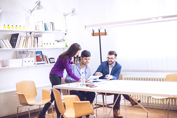 istock Team of three young people cooperating in the office 502933624