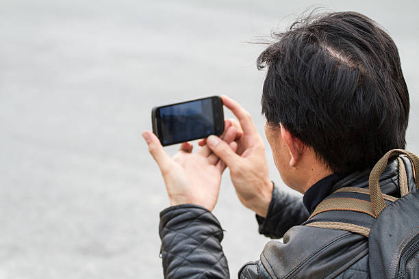 istock mobile phone camera in male hands 502936863