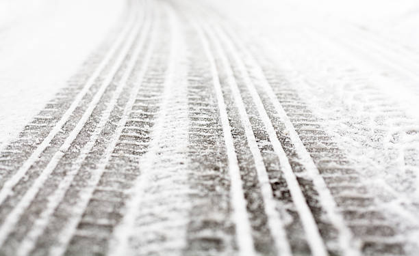 istock Wheel tracks on the road covered with snow 502943296