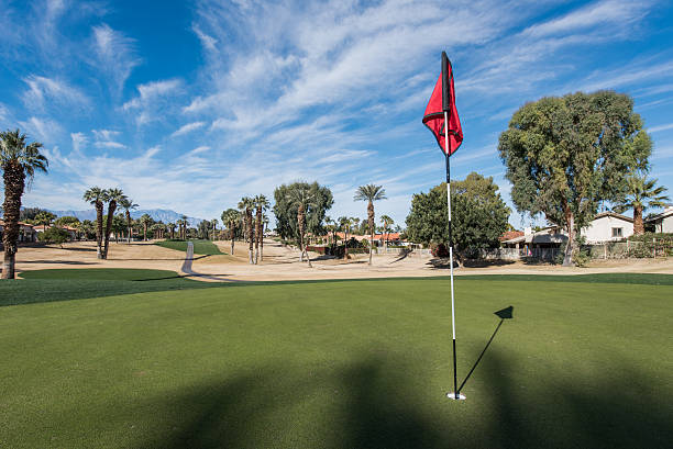 istock Golf course green with flag in hole 502945374