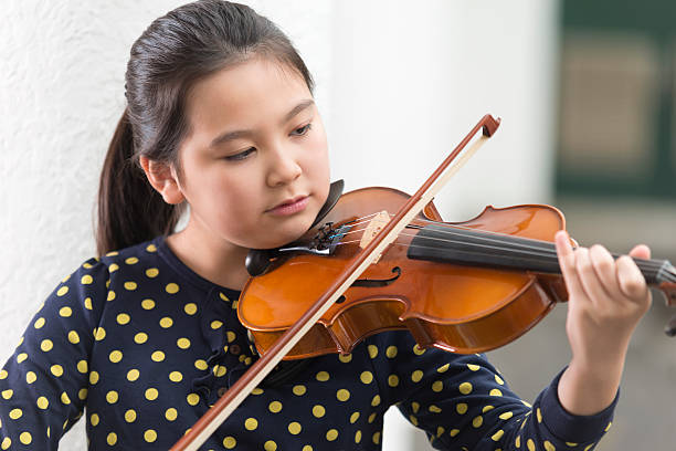 istock Little Girl Playing Violin 502945378