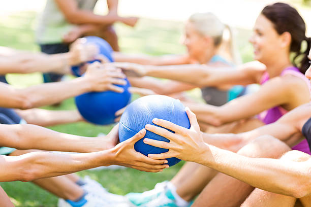 istock Bootcamp Class Exercising With Medicine Balls In Park 502950893