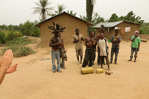Ntandi, Uganda - March 6, 2012: Pygmies are dancing in the village and play musical instruments