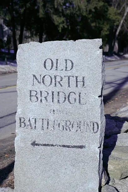 A granite marker points to the location of the Old North Bridge and Battleground that marked the beginning of the US Revolution.