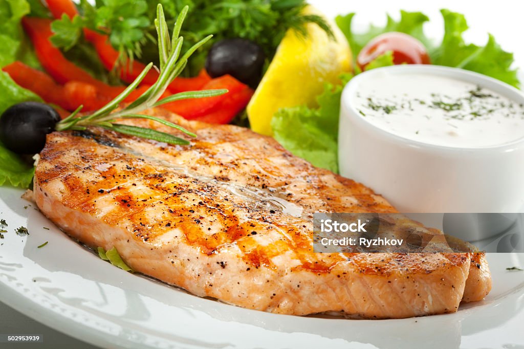 Salmon Steak Grilled Salmon with Vegetables, Eggs and Sour Cream Sauce Baked Stock Photo