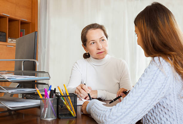istock Mature woman talking with employee 502954203