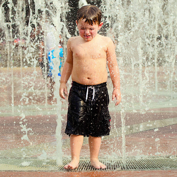 istock Unhapppy child in water fountains 502958061
