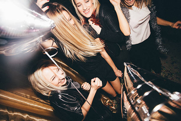 Girls on a dance floor Group of young women dancing in a nightclub, having the time of their lives ladies night stock pictures, royalty-free photos & images