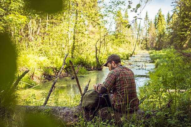 istock Man Resting Alone by the Riverside in the Woods 502967620