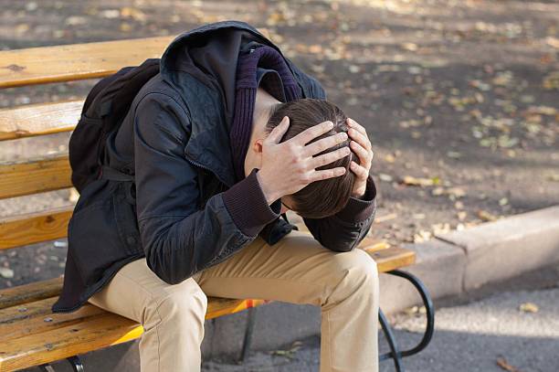 istock Man sitting on a bench and holding his head 502969210