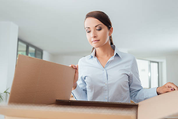 istock Happy woman unpacking 502970210