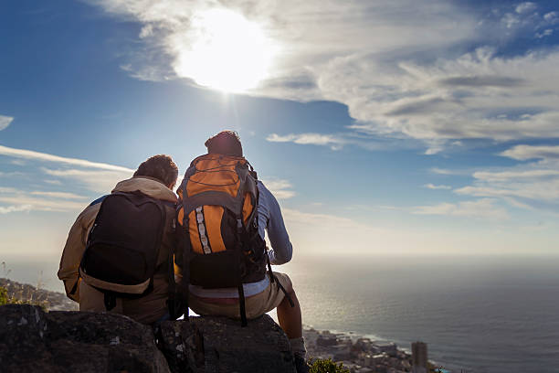 istock Gay hikers sitting on rocks against sky 502970780