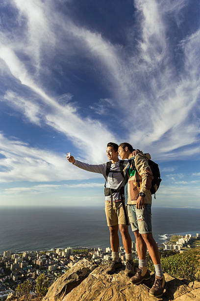 istock Hikers taking selfie through mobile phone on cliff 502971048