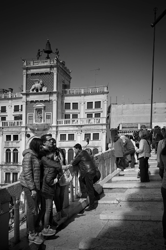 Venice, Italy - April 11, 2015: Couple having their photograph taken on the roof of the basillica in St Mark's Square in Venice.