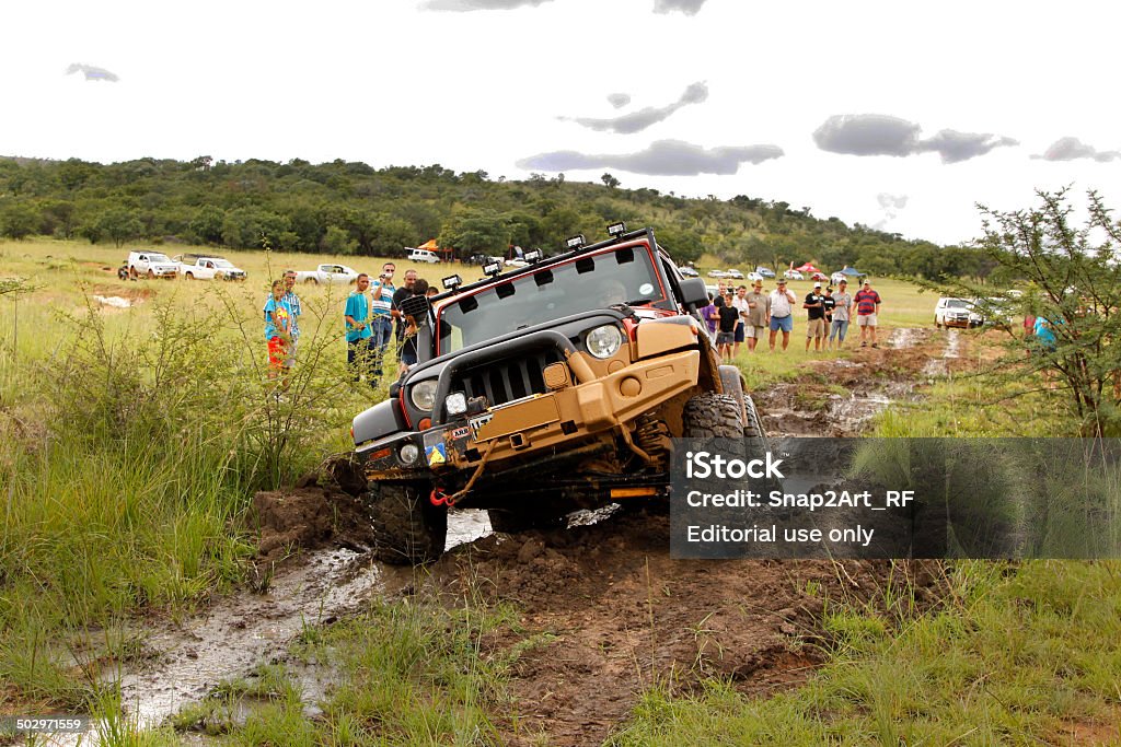Crush Beige Jeep Rubicon crossing mud obstacle Bafokeng, Rustenburg, South Africa - March 8, 2014: Crush Beige Jeep Rubicon crossing mud obstacle Jeep Stock Photo