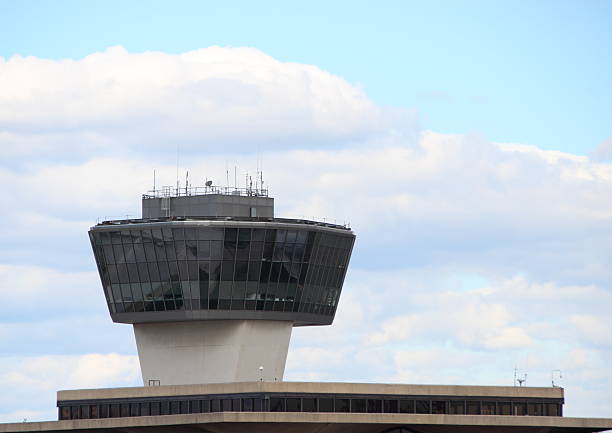 Airport Control Tower with Clouds and Blue Sky