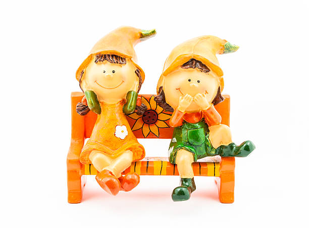 istock Boy and Girl Dolls sitting on Bench 502972229