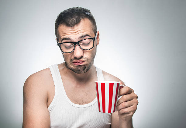 Funny sleepy man with cup coffee stock photo