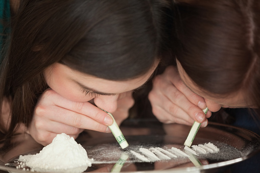Dos chicas jóvenes esnifar ilegal de polvo blanco photo