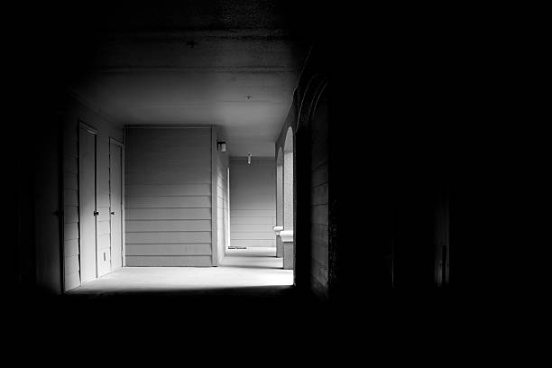 istock dark corridor leading to outside light 502975985