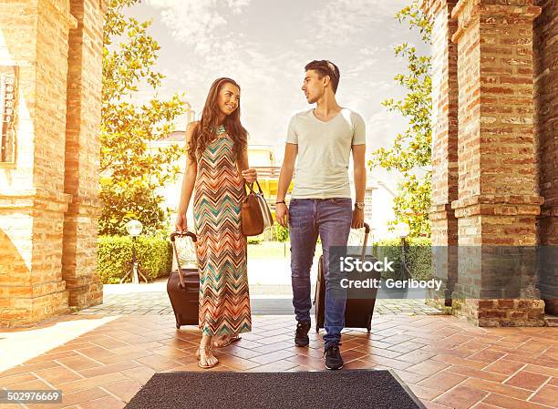 Young Couple Standing At Hotel Corridor Upon Arrival Stock Photo - Download Image Now