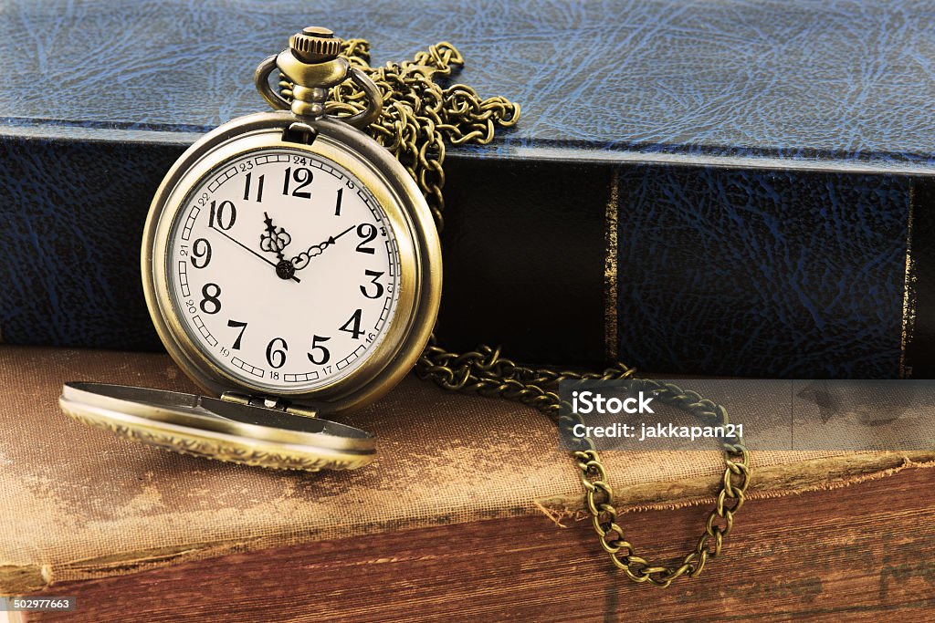 pocket watch Vintage grunge still life with antique pocket watch, and old book Antique Stock Photo