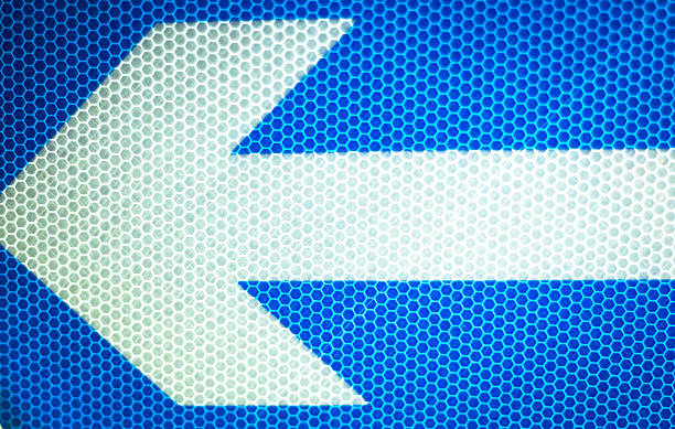 Traffic road sign arrow in street photograph.