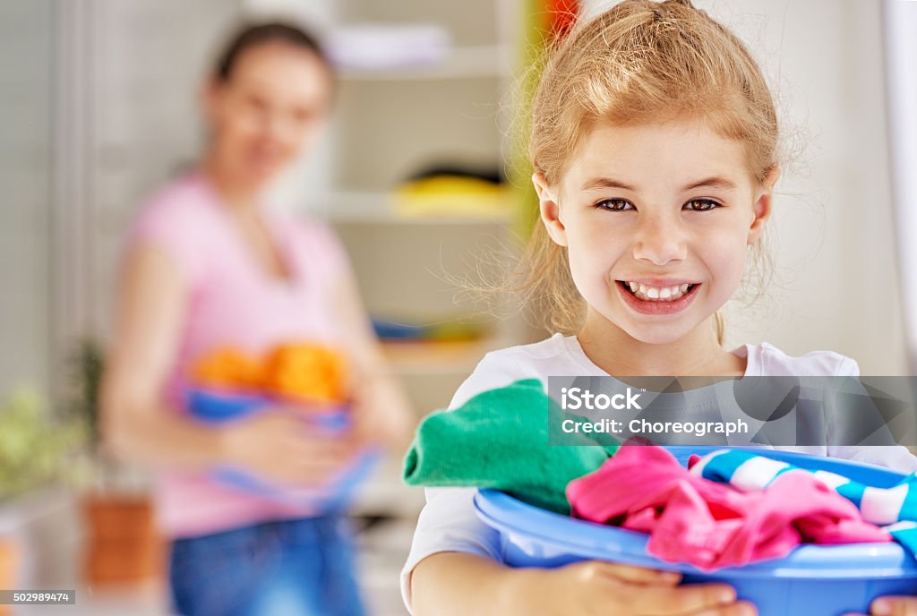 housewife family with a basin full of laundry Child Stock Photo