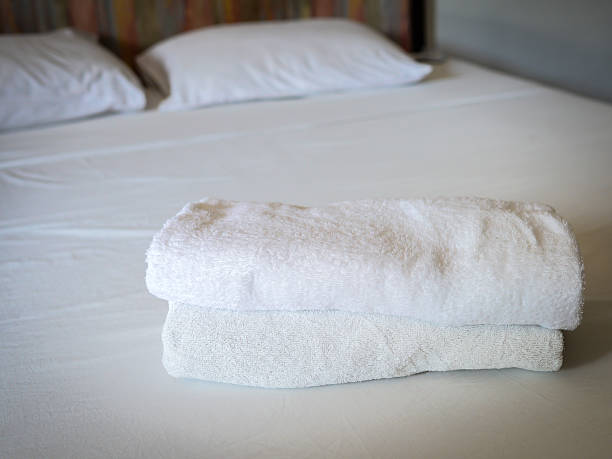istock Stacked white spa towels on bed 502991653