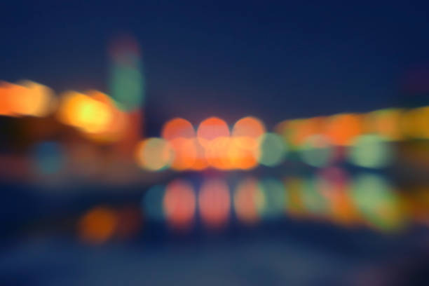 istock City at night blurred photo with reflection in water 502992340