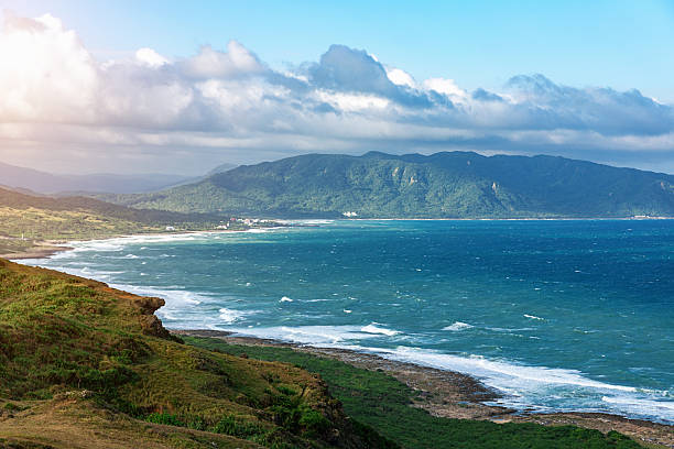 Sun over Kenting National Park at Taiwan's South Coast with an awesome mountain range and beautiful coastline, Taiwan. 