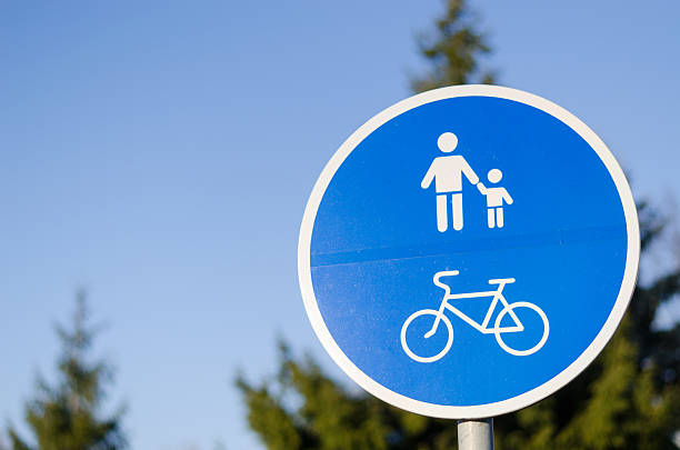 bicycle and pedestrian lane road sign on pole post in blue, walkway footpath route traffic roadside traffic sign