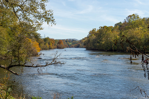 The French Broad River in Asheville with a kayaker in the far background