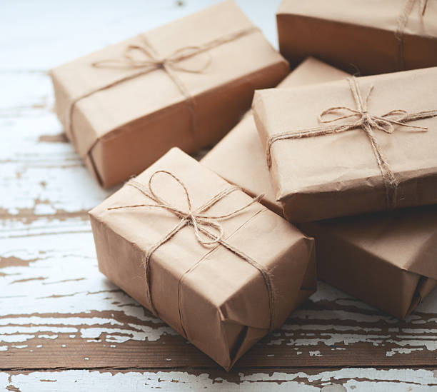 istock gift boxes wrapped in brown paper on old wooden background 502996562