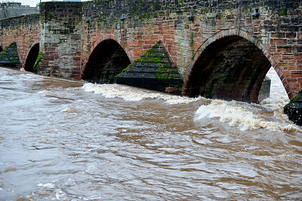 istock Swollen river passing under an old sandstone bridge 502996852