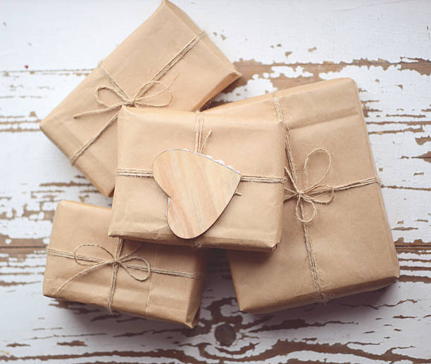 istock gift boxes wrapped in brown paper on old wooden background 502996884