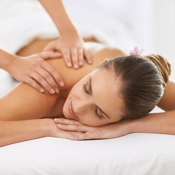 Relaxed by magical hands Cropped shot of a gorgeous young woman enjoying a massage spa lady stock pictures, royalty-free photos & images