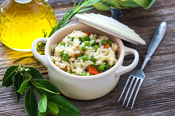 Rice with vegetables on wooden background