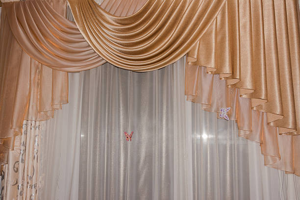 istock Open lambrequin golden color on the window 502998385