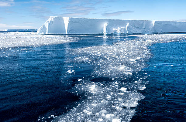 Tabular Iceberg and Brash Ice, Antarctica This tabular iceberg is part of the B-15 iceberg that broke off from Antarctica ice shelf in 1980 in the Ross Sea.  This is part of a piece of that ieceberg referredt to as B-15y and was seen in the Antarctic Sound in early November, 2015. antarctic peninsula photos stock pictures, royalty-free photos & images