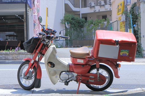 Kobe Japan - 2 June 2014:Iconic Japan Post’s motorbike parked in Kobe Japan.