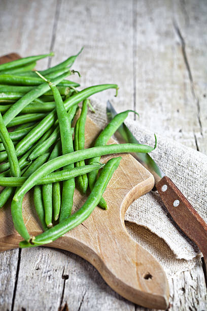 green string beans and knife stock photo