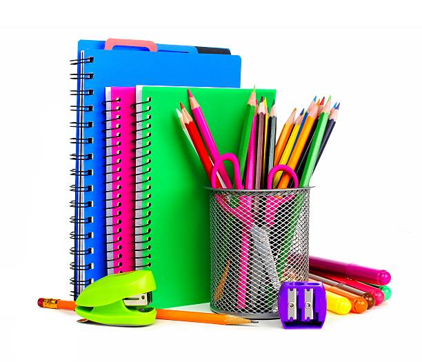 Notebooks and school supplies Group of colorful school notebooks and supplies over a white background stapled paper stock pictures, royalty-free photos & images